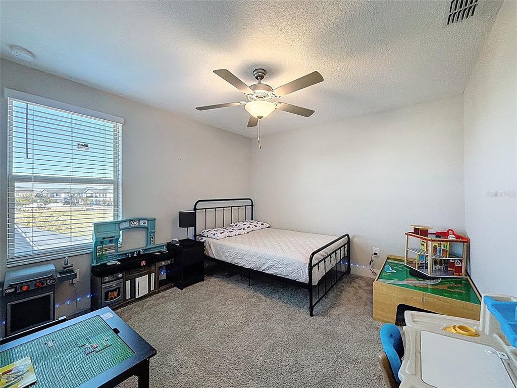 8124 Olympic Stone Circle Trinity, FL 34655 - Photo 52 of 75 a bedroom with furniture and a window
