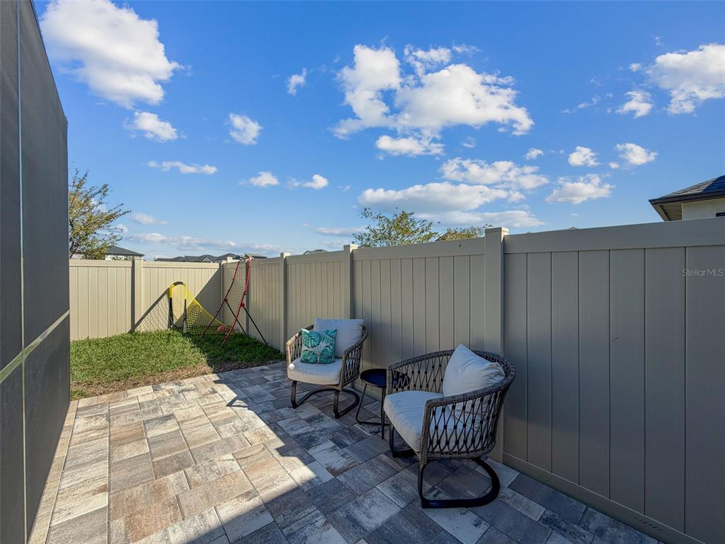 8124 Olympic Stone Circle Trinity, FL 34655 - Photo 54 of 75 a view of a chair and tables in the patio