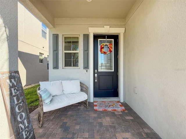 a living room with furniture ceiling fan and a flat screen tv