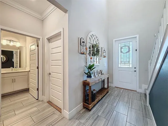 a living room with furniture and a view of kitchen
