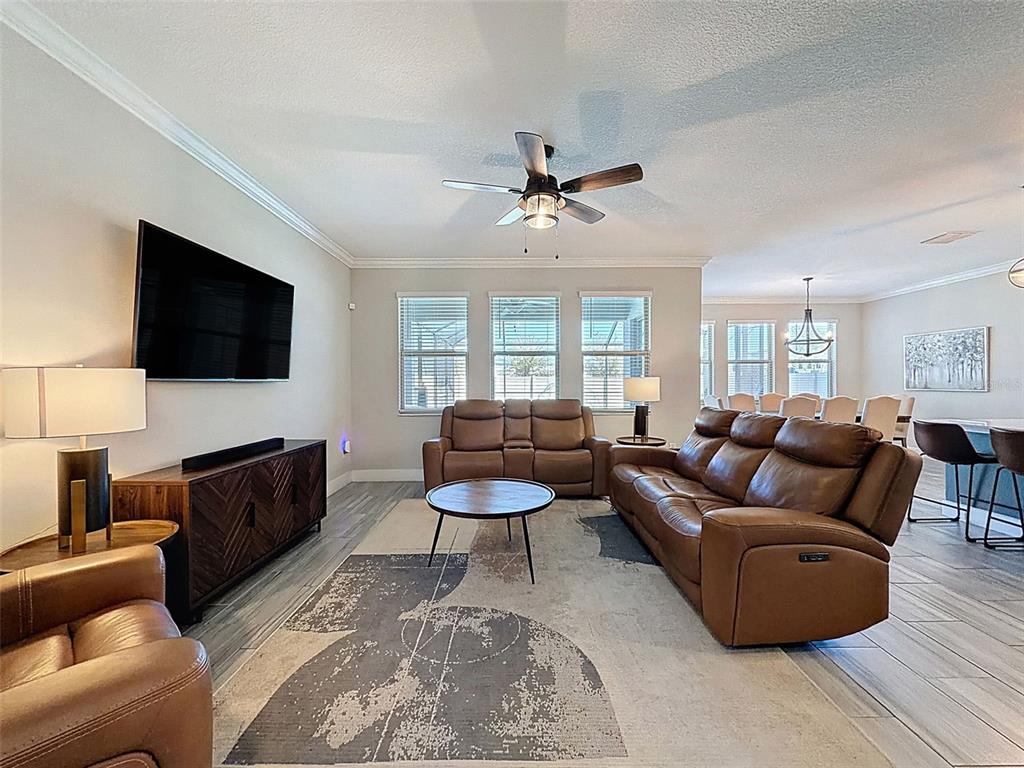 8124 Olympic Stone Circle Trinity, FL 34655 - Photo 9 of 75 a living room with furniture and a flat screen tv