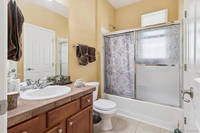 a bathroom with a tub a sink and a window