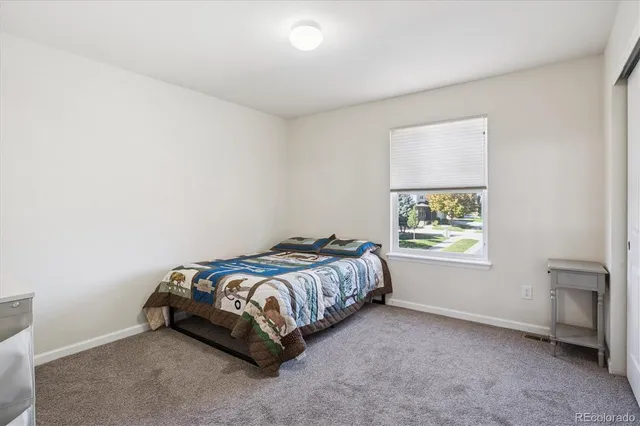 a view of an outside dining space with a table and chairs