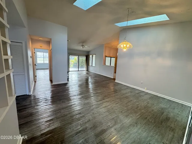 a kitchen with stainless steel appliances a refrigerator sink and white cabinets