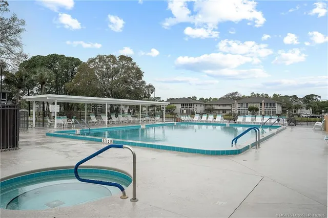 a view of a swimming pool with a lounge chair