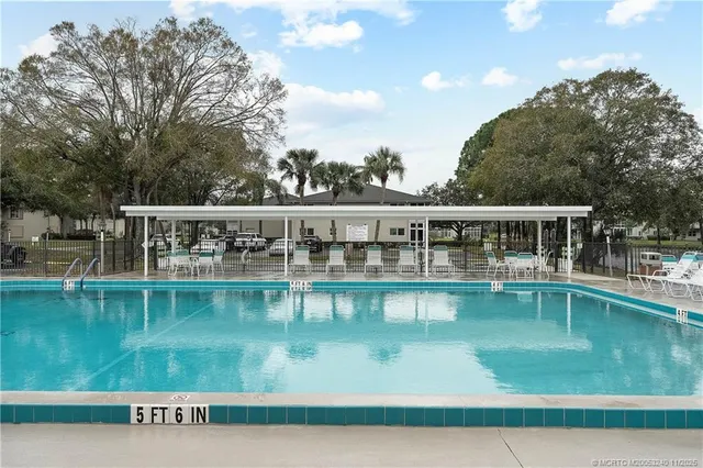 a view of a swimming pool with a yard