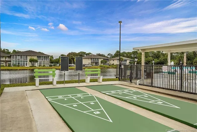 a view of a balcony with a floor to ceiling window next to a yard