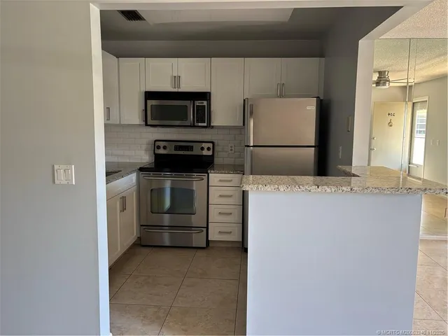 a kitchen with a refrigerator sink and microwave
