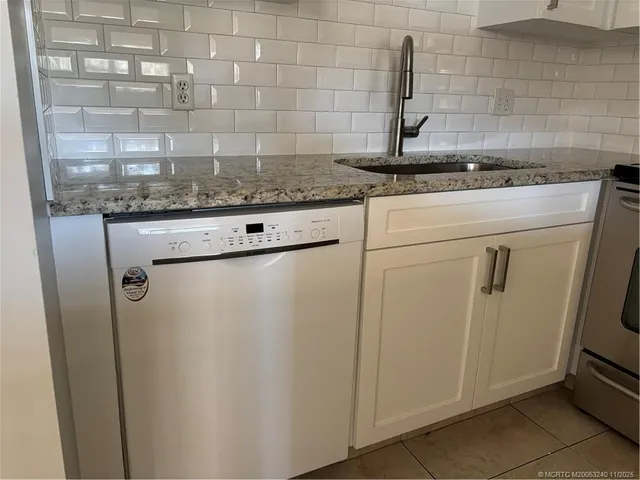 a view of a refrigerator and sink