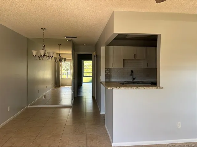 a view of a hallway with wooden shelves