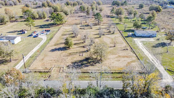 a view of swimming pool with large trees and seating space
