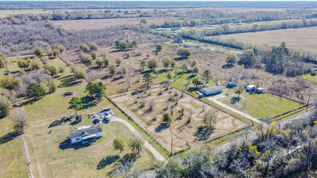 an aerial view of a house with a backyard