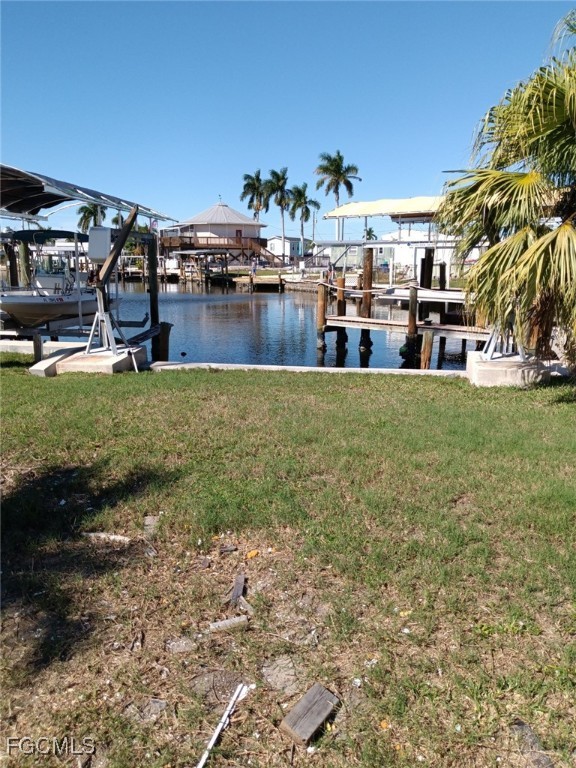 2413 York Road St. James City, FL 33956 - Photo 5 of 5 a view of a lake with building and car parked