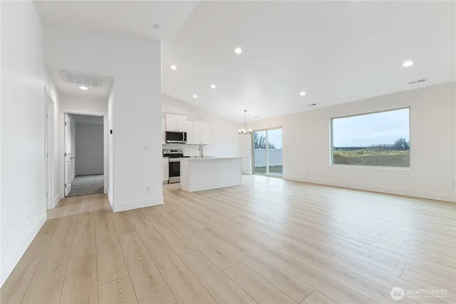 a view of a kitchen with a sink and a refrigerator