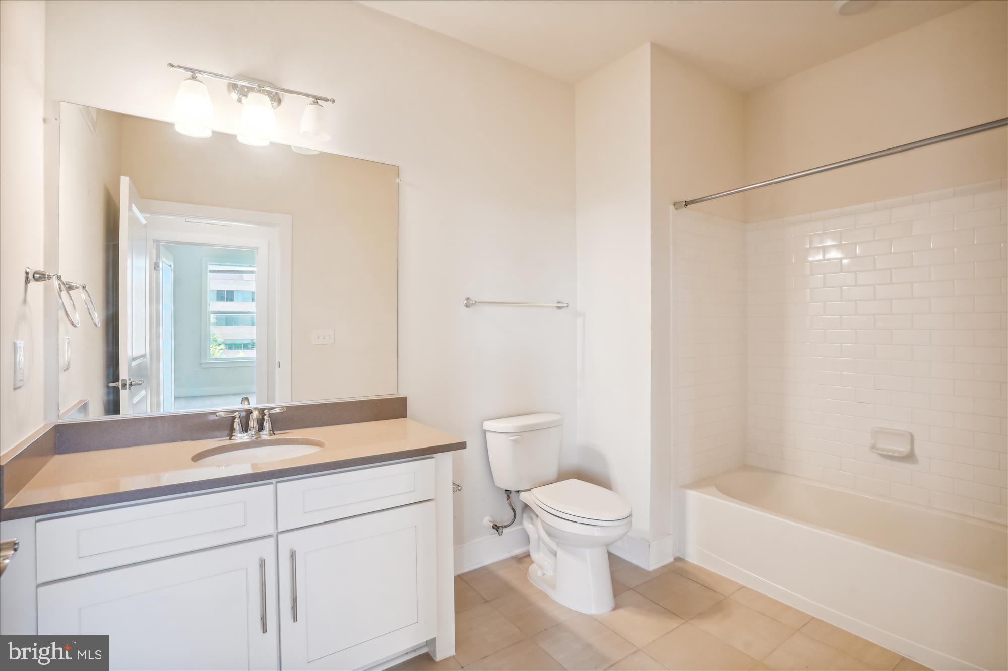 11200 Reston Station Boulevard, Unit 306 Reston, VA 20190 - Photo 19 of 53 a bathroom with a sink a toilet and a bathtub