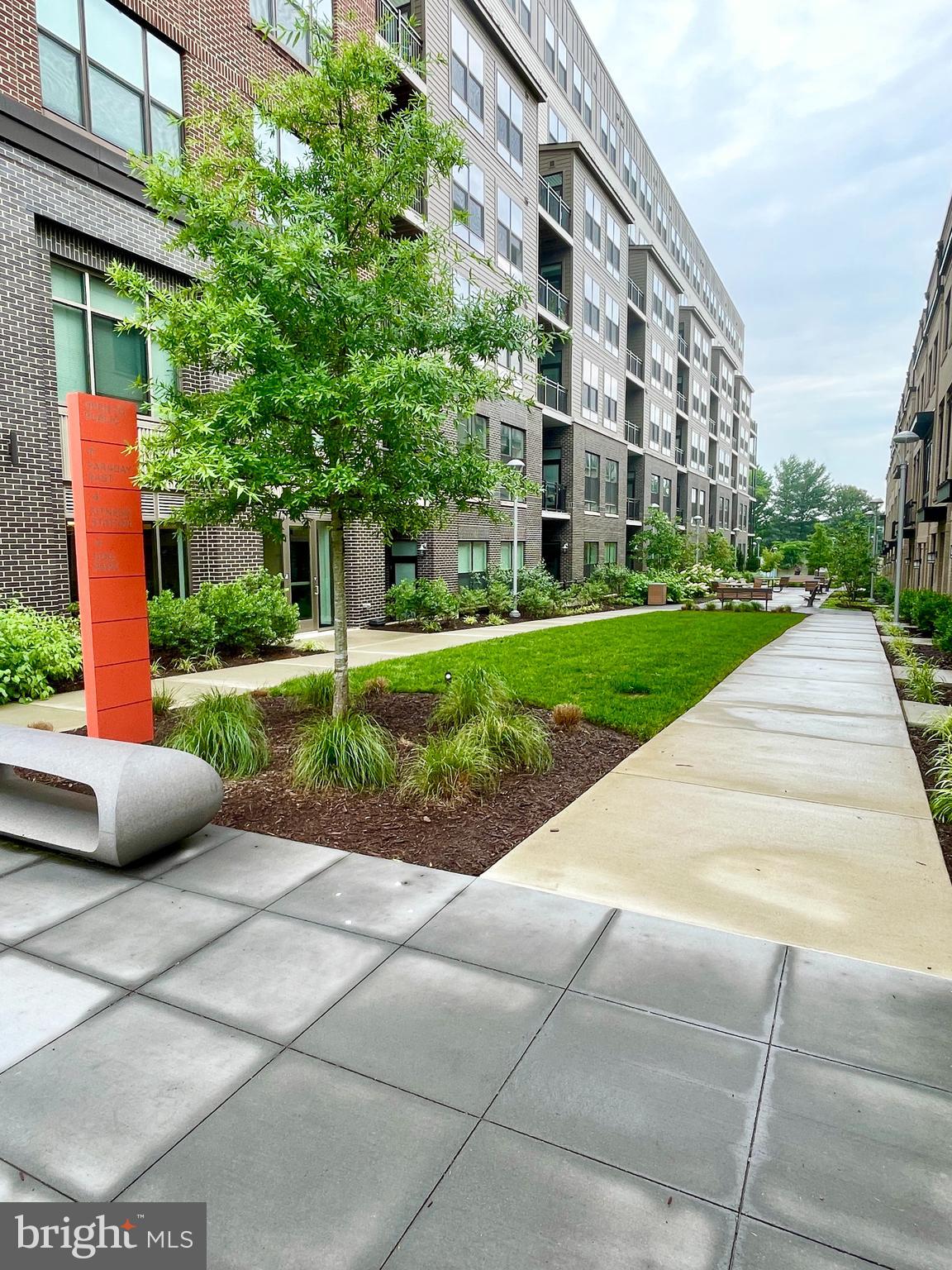 11200 Reston Station Boulevard, Unit 306 Reston, VA 20190 - Photo 21 of 53 a view of a building with a garden and pathway