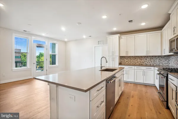 a kitchen with a sink stove and cabinets