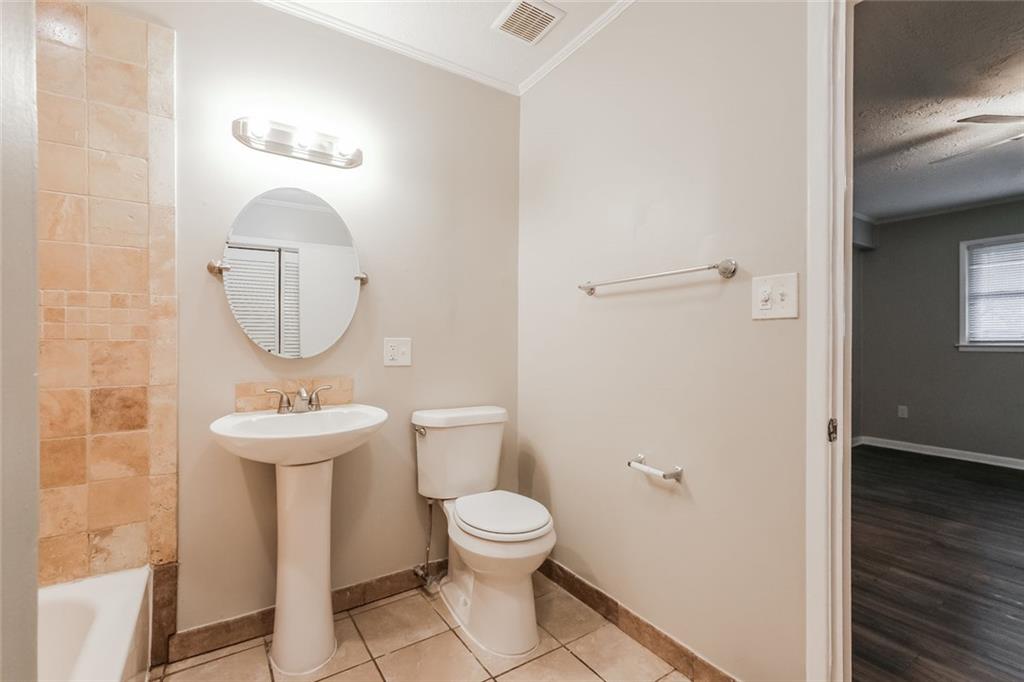 2965 Judylyn Drive Decatur, GA 30033 - Photo 21 of 26 a bathroom with a toilet a sink and mirror