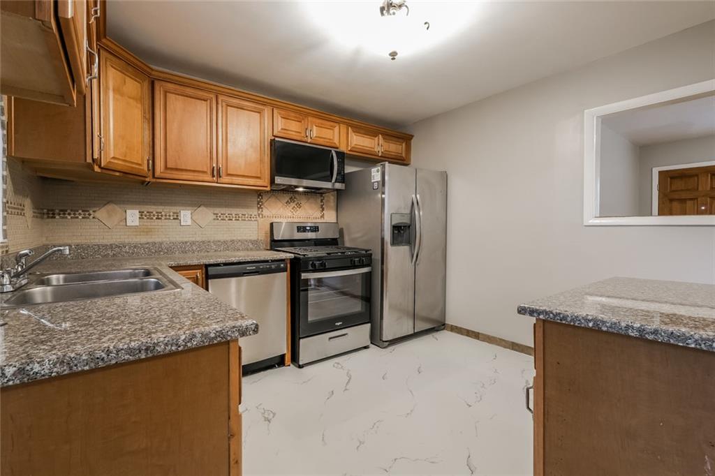 2965 Judylyn Drive Decatur, GA 30033 - Photo 7 of 26 a kitchen with stainless steel appliances granite countertop a refrigerator sink and stove