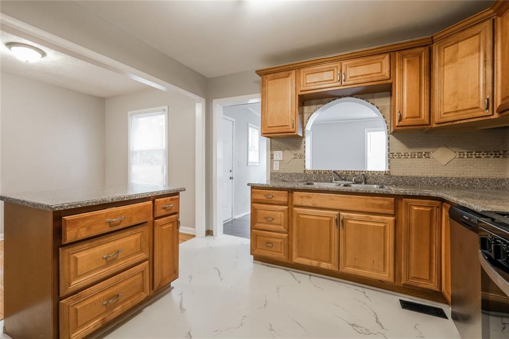 2965 Judylyn Drive Decatur, GA 30033 - Photo 8 of 26 a kitchen with granite countertop cabinets stainless steel appliances and a sink