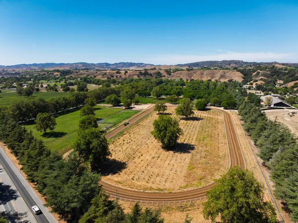 an aerial view of residential houses with outdoor space