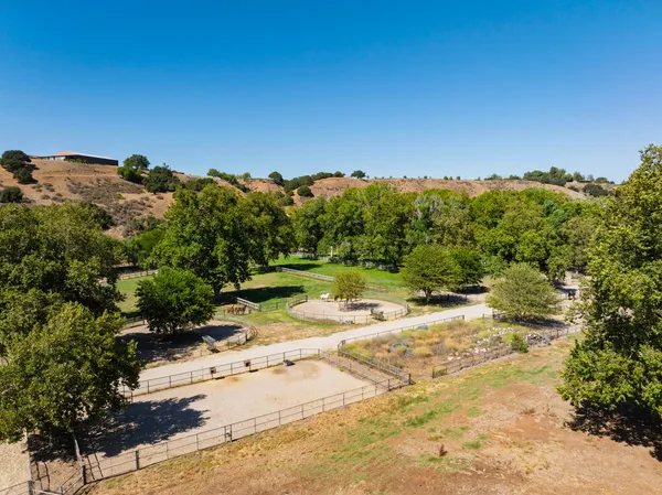 an aerial view of mountain with yard