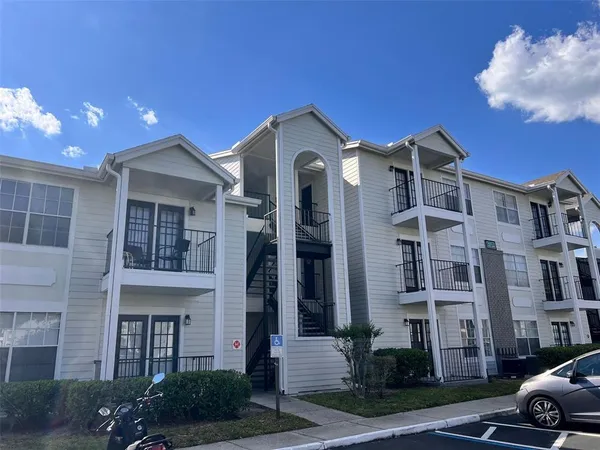 a front view of a residential apartment building with a yard