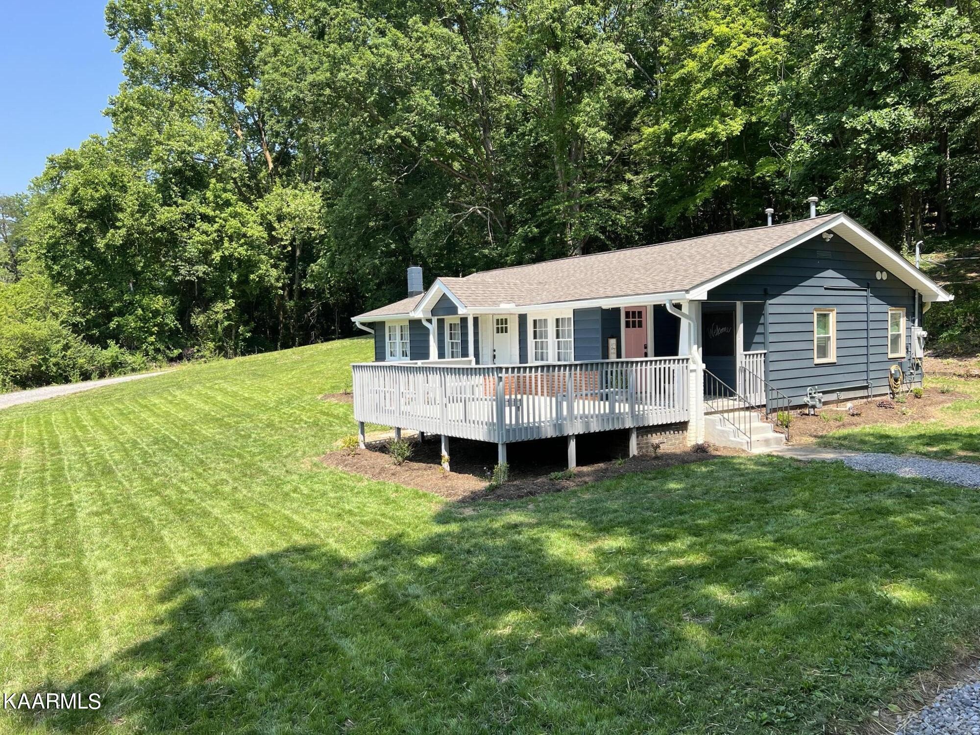679 Blockhouse Valley Road Clinton, TN 37716 - Photo 1 of 45 a view of a house with a backyard and deck