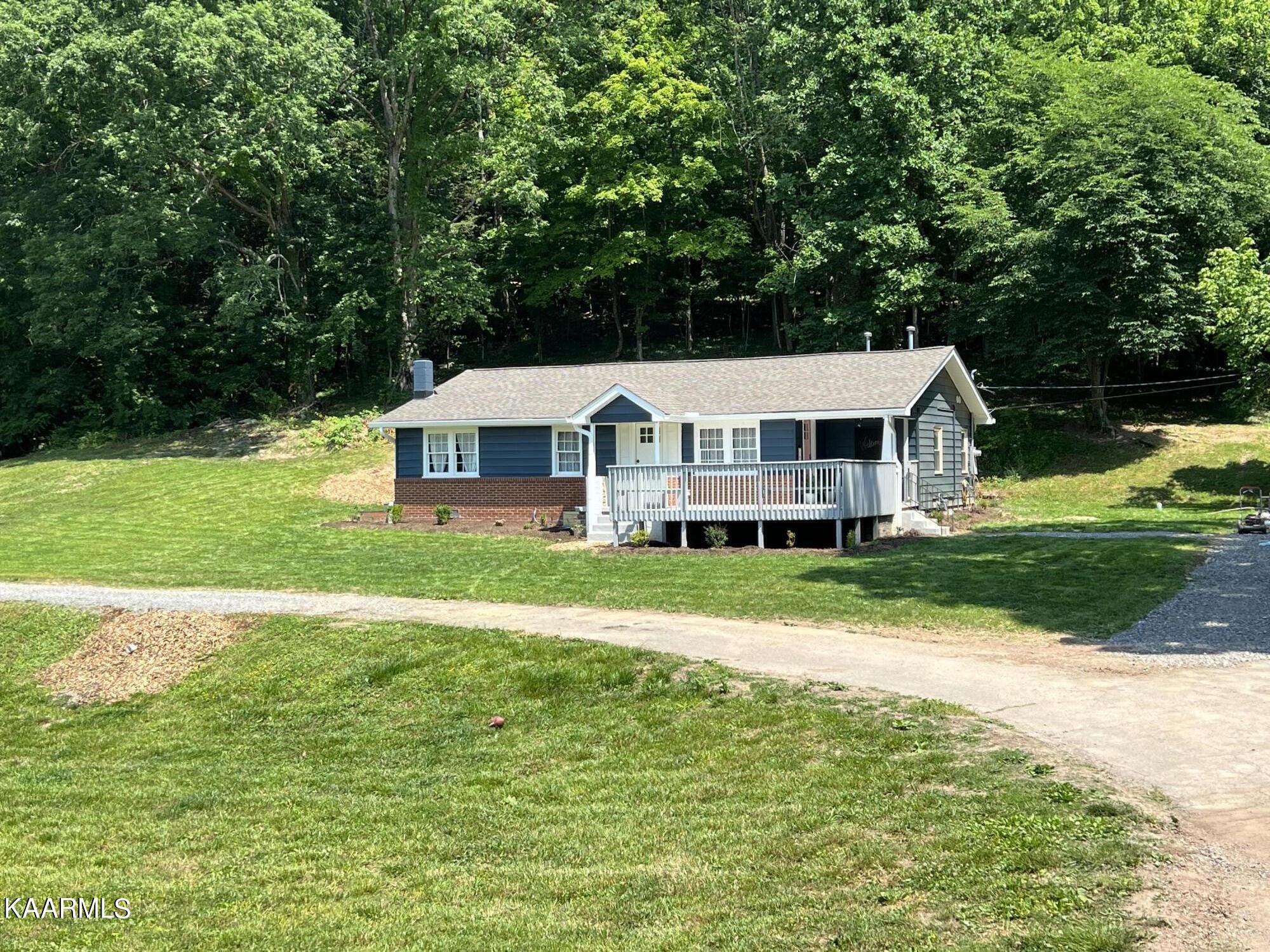 679 Blockhouse Valley Road Clinton, TN 37716 - Photo 3 of 45 a aerial view of a house with a yard table and chairs