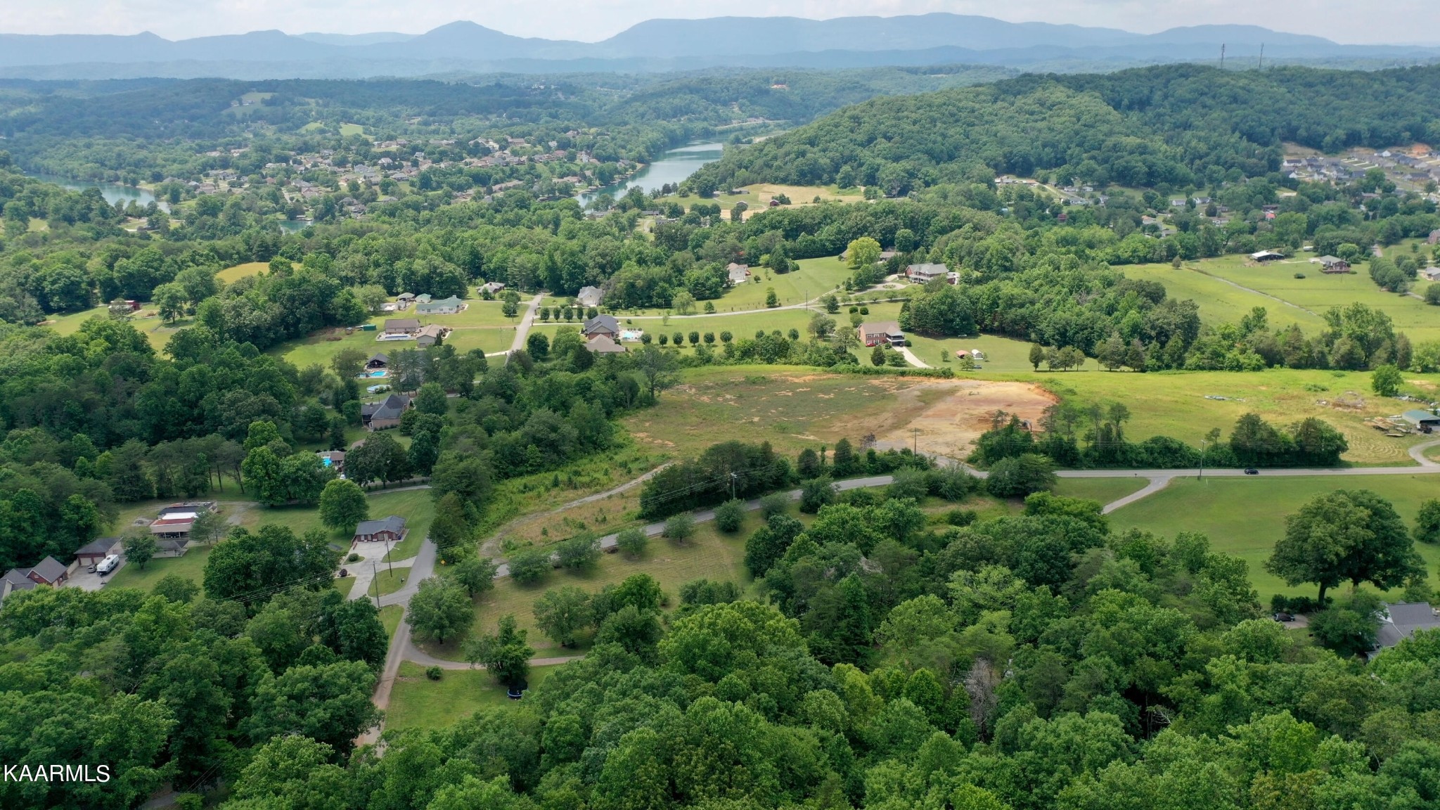 679 Blockhouse Valley Road Clinton, TN 37716 - Photo 40 of 45 an aerial view of green landscape with trees and houses