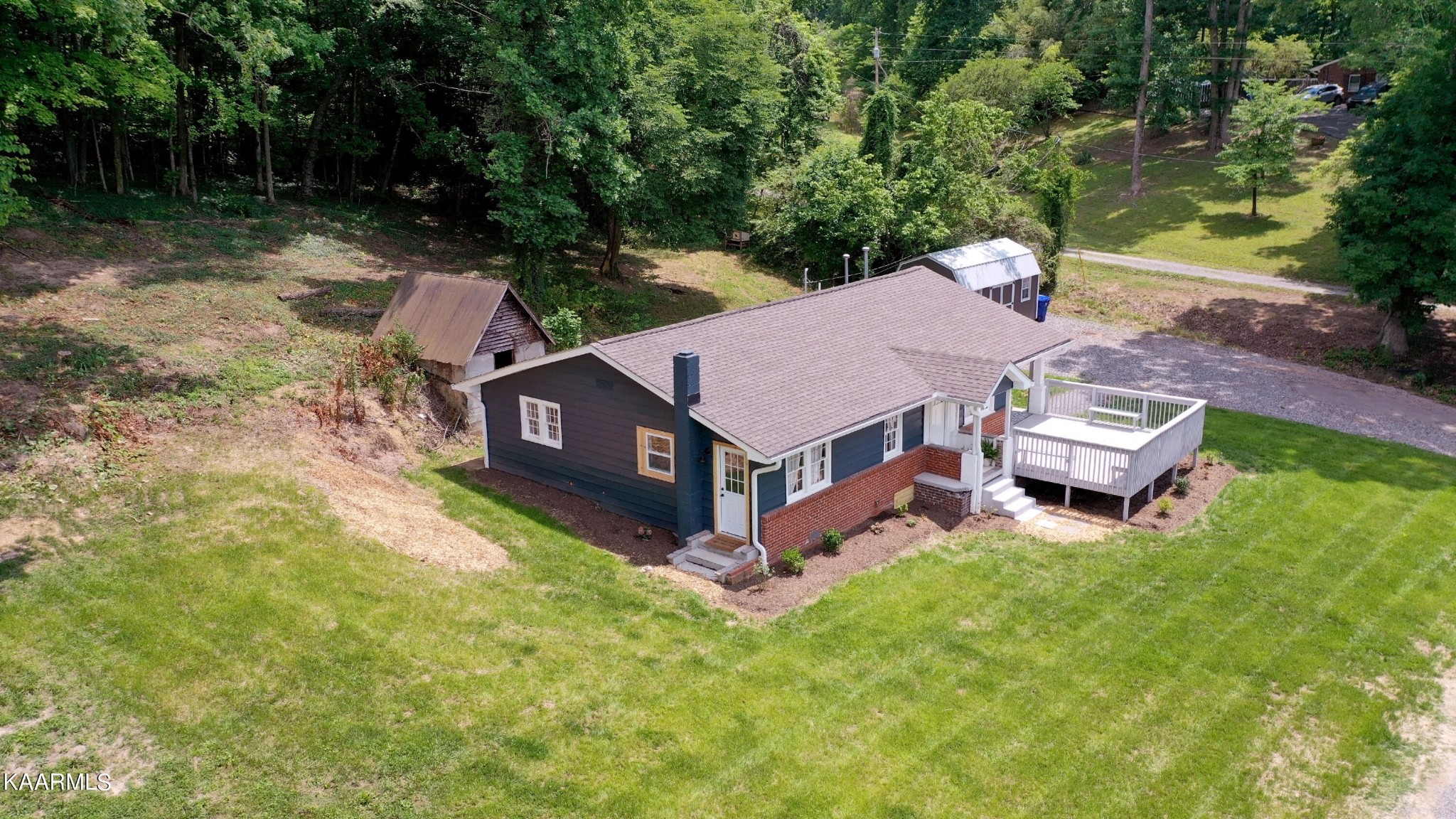 679 Blockhouse Valley Road Clinton, TN 37716 - Photo 7 of 45 a aerial view of a house with a yard table and chairs