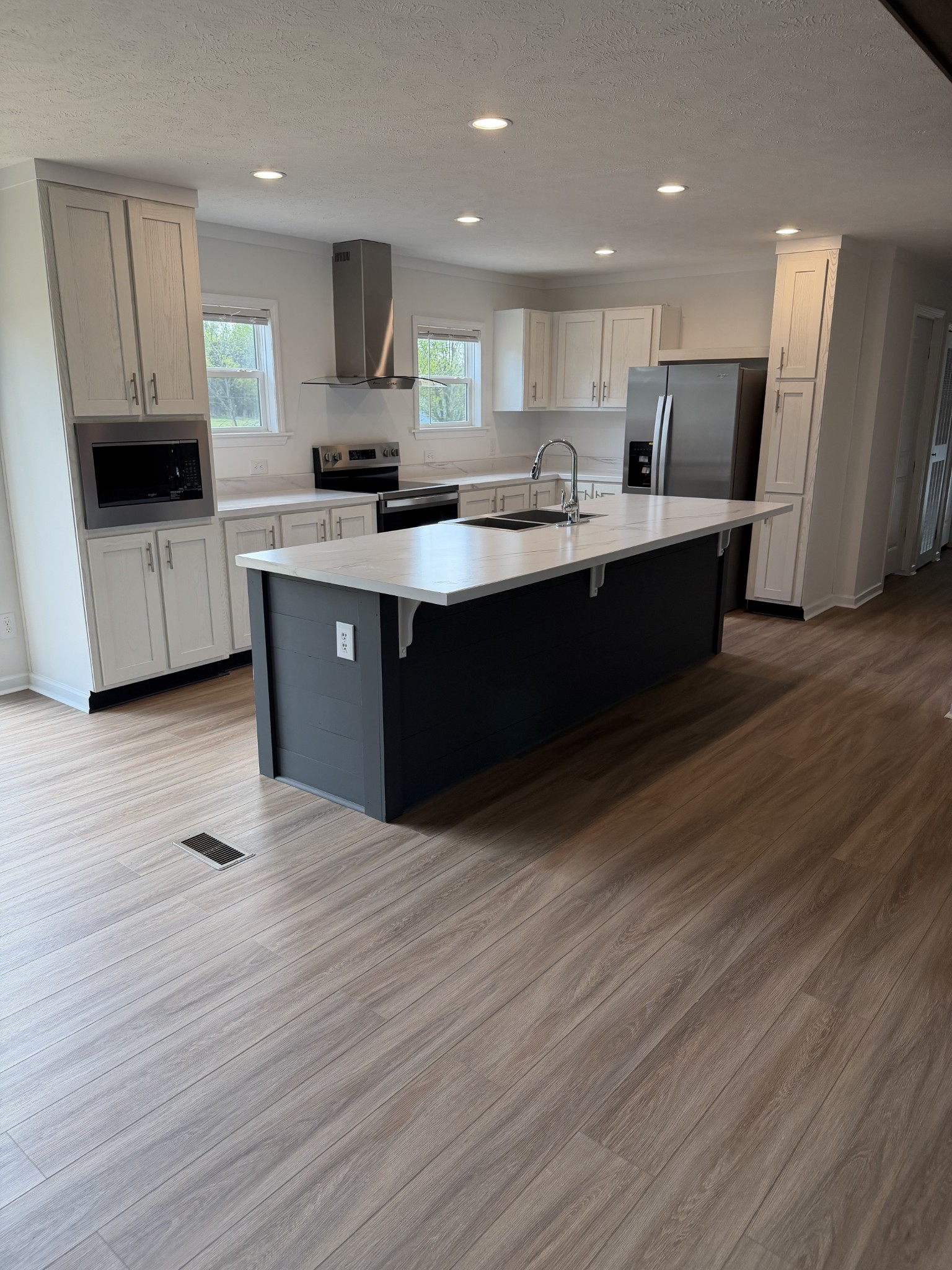 2334 Deans Shop Road Estill Springs, TN 37330 - Photo 3 of 9 a kitchen with stainless steel appliances kitchen island granite countertop a stove a sink and a refrigerator