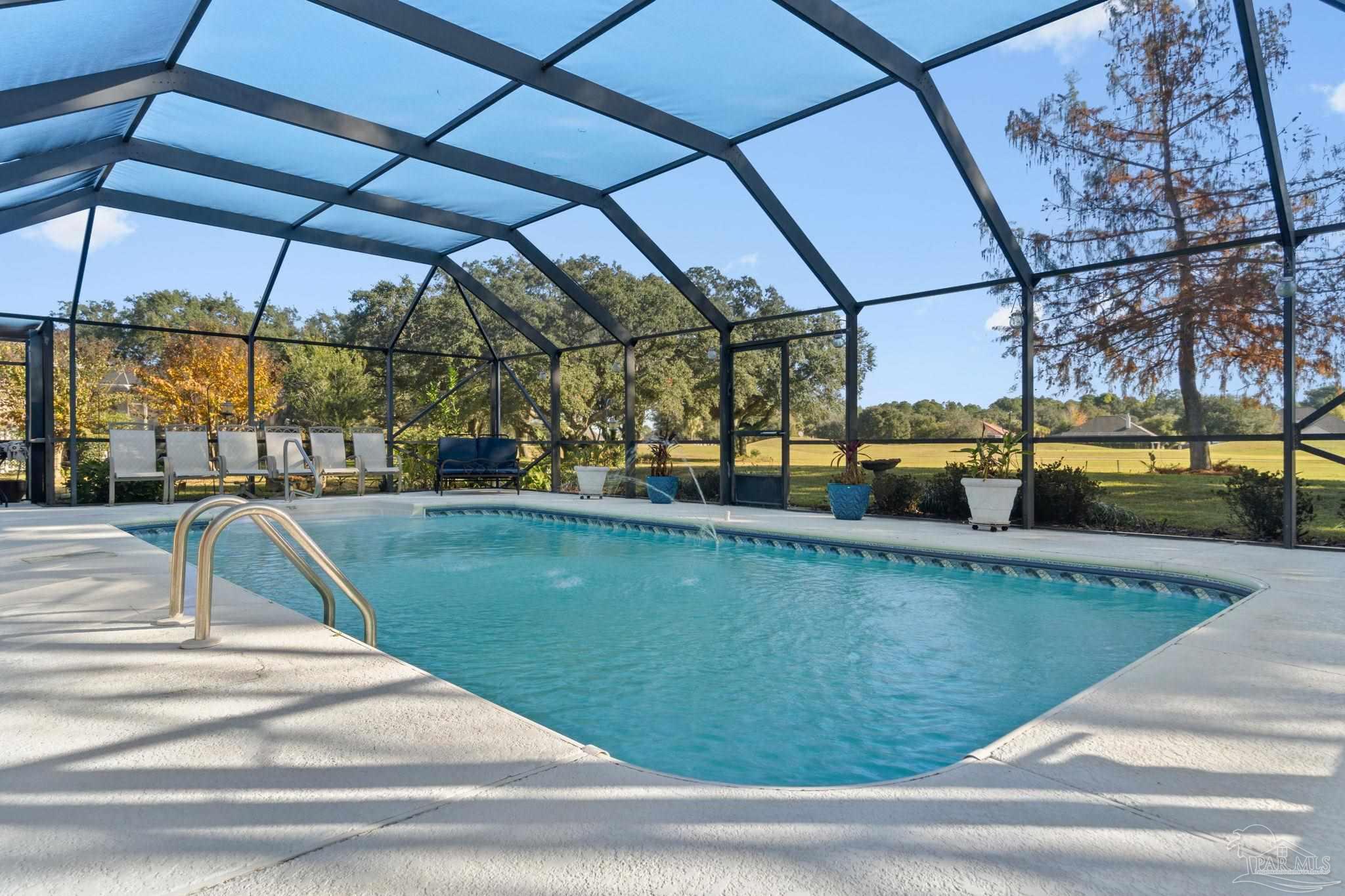 2640 Masters Boulevard Navarre, FL 32566 - Photo 2 of 40 a view of a swimming pool with a patio