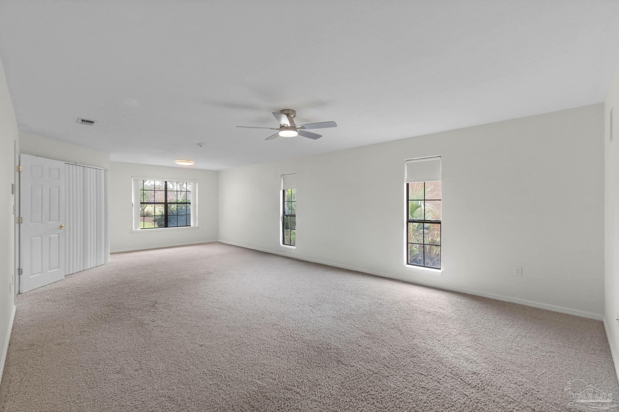 2640 Masters Boulevard Navarre, FL 32566 - Photo 21 of 40 a view of a livingroom with a ceiling fan and window