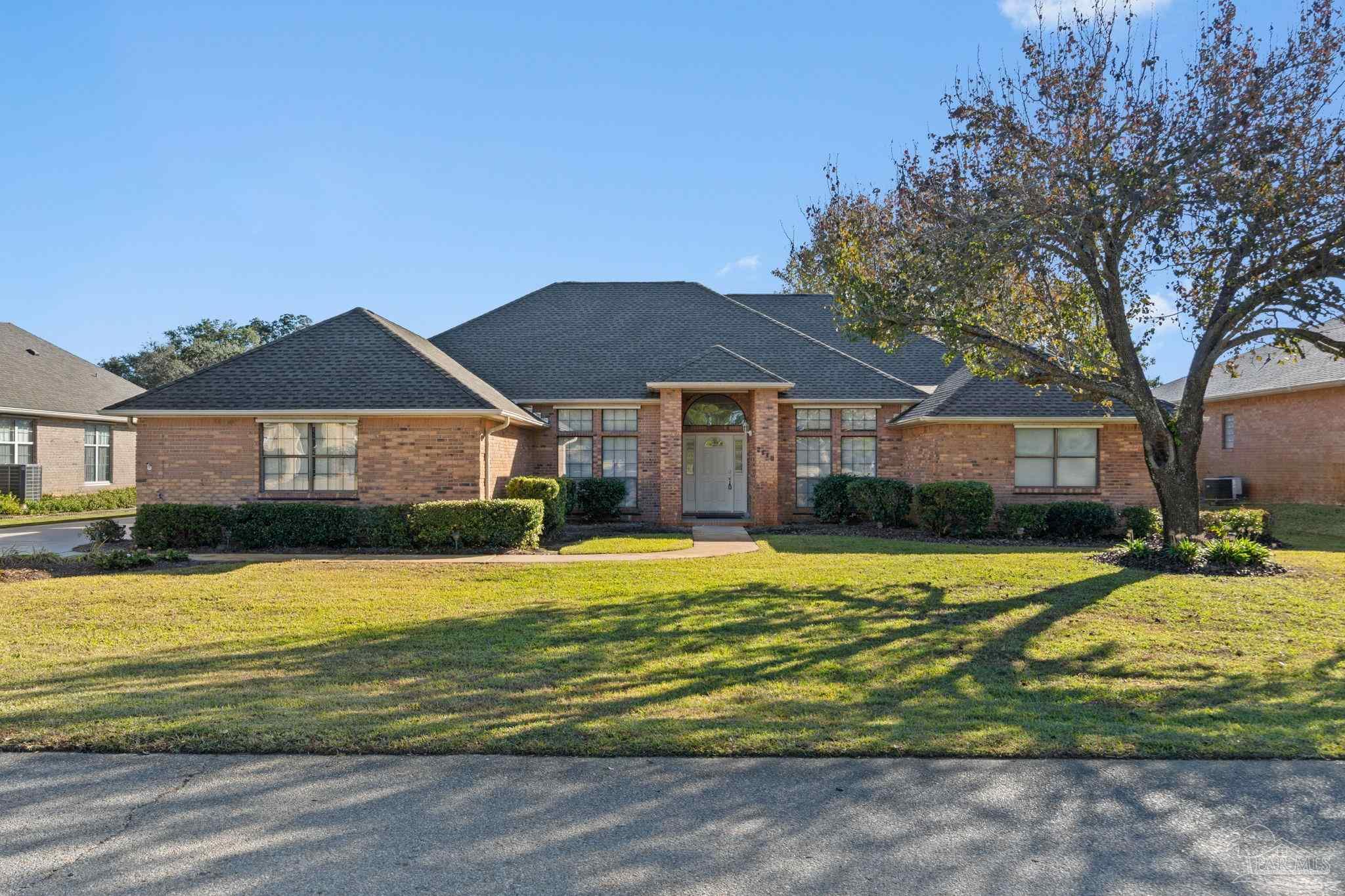 2640 Masters Boulevard Navarre, FL 32566 - Photo 3 of 40 a house with swimming pool in front of it
