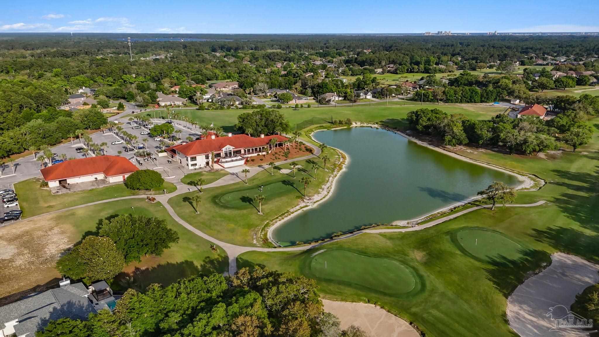 2640 Masters Boulevard Navarre, FL 32566 - Photo 31 of 40 an aerial view of a golf course with a lake view