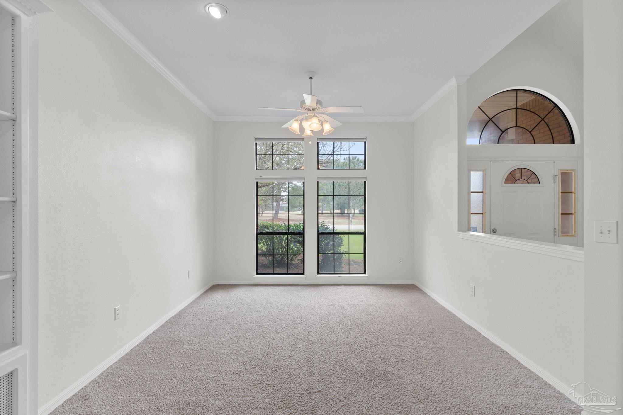 2640 Masters Boulevard Navarre, FL 32566 - Photo 6 of 40 an empty room with windows and entrance