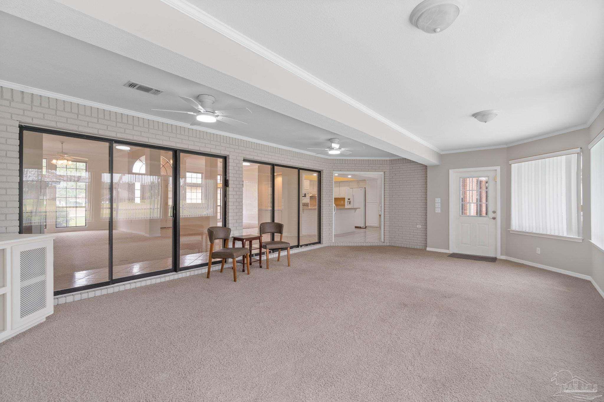 2640 Masters Boulevard Navarre, FL 32566 - Photo 8 of 40 a big room with windows and view of balcony