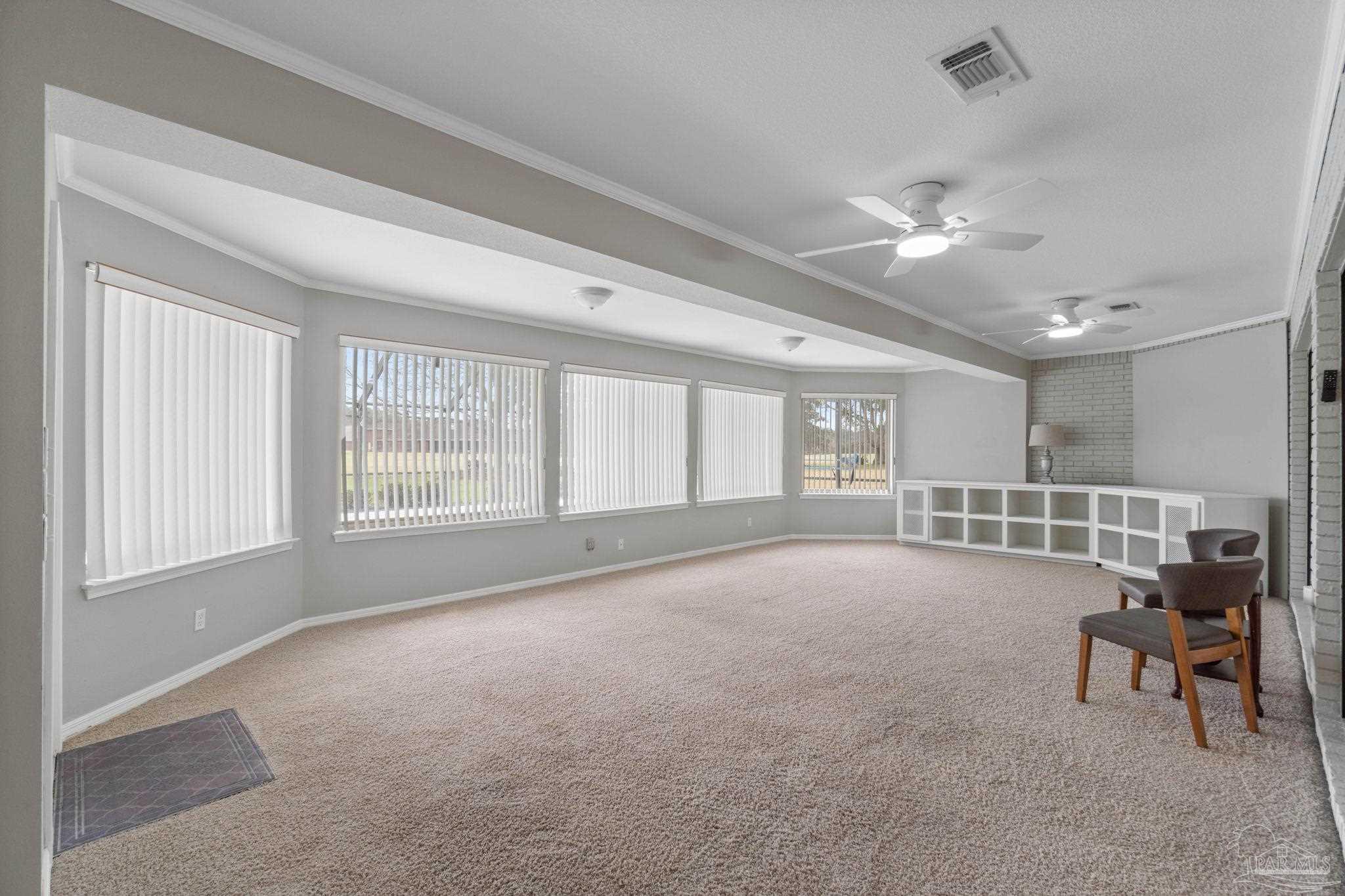2640 Masters Boulevard Navarre, FL 32566 - Photo 9 of 40 a living room with furniture and windows