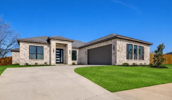 a front view of house with yard and green space