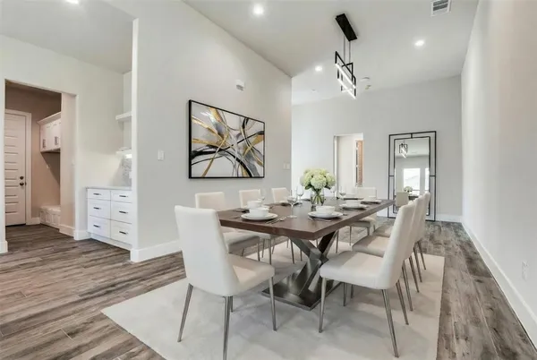 a view of a dining room with furniture and wooden floor