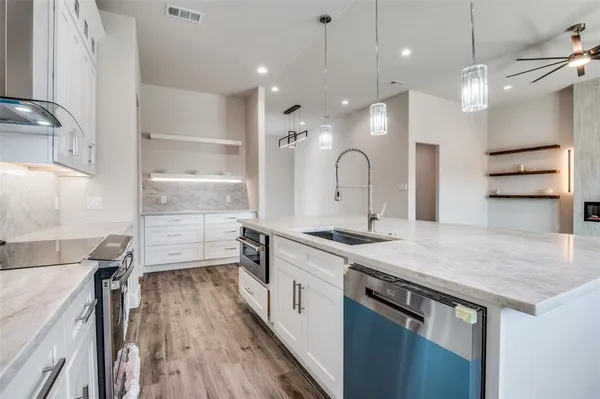 a kitchen with a stove a sink and a refrigerator