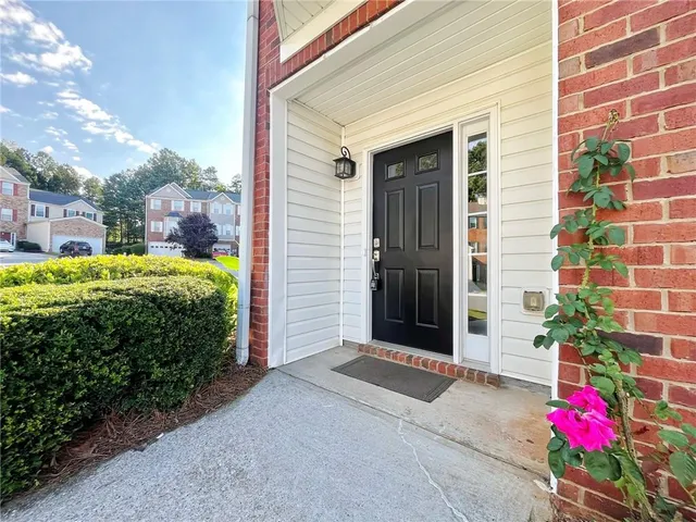 a view of a house with potted plants