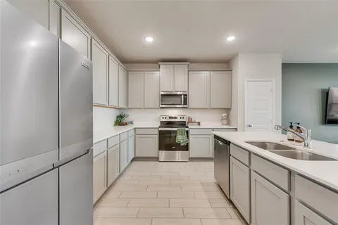 a kitchen with appliances cabinets and a sink