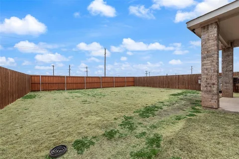 a view of backyard with trampoline