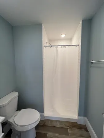 a bathroom with a toilet and a shower