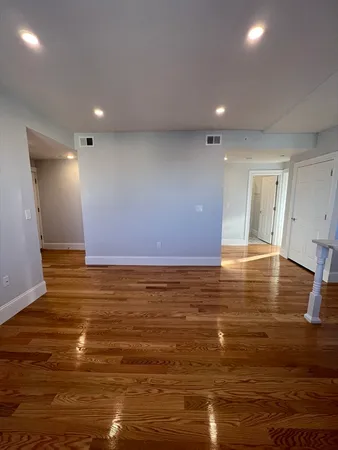a view of room with wooden floor