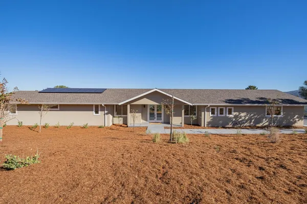 a front view of a house with a yard