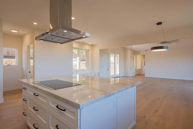 a kitchen with stainless steel appliances white cabinets and a refrigerator