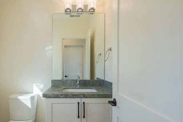 a hallway with windows and chandelier